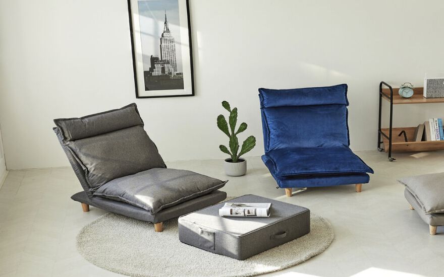 living room setting with two lounge chairs, one blue and one dark grey