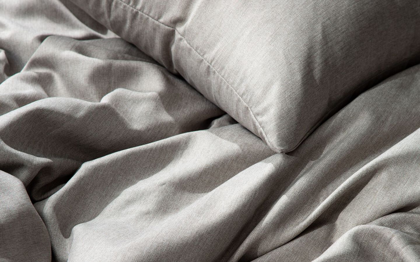Closeup image of grey fabric bedding