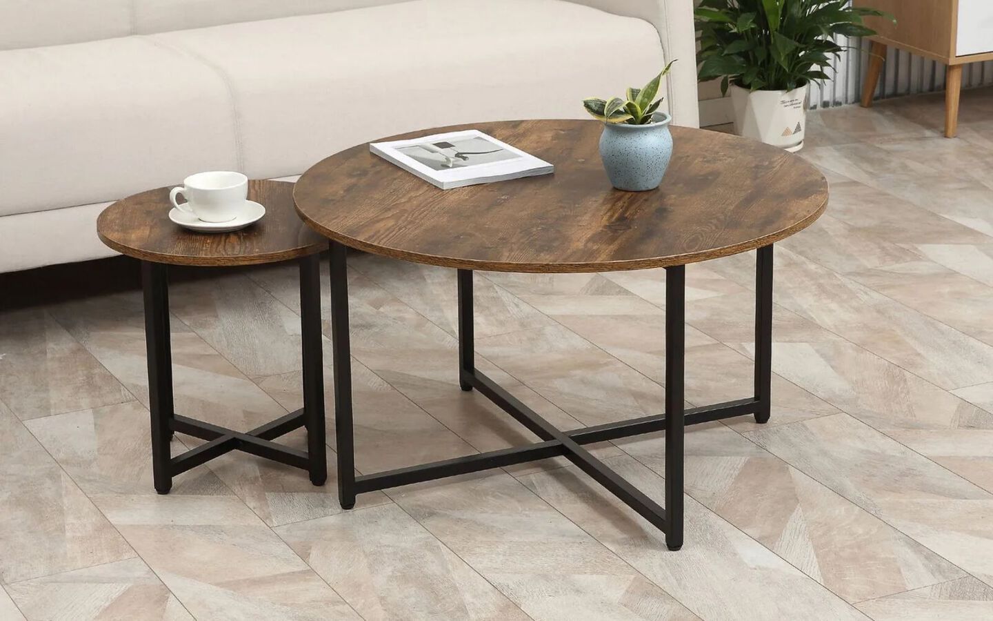 One large and on small brown and black coffee circular coffee table with metal legs