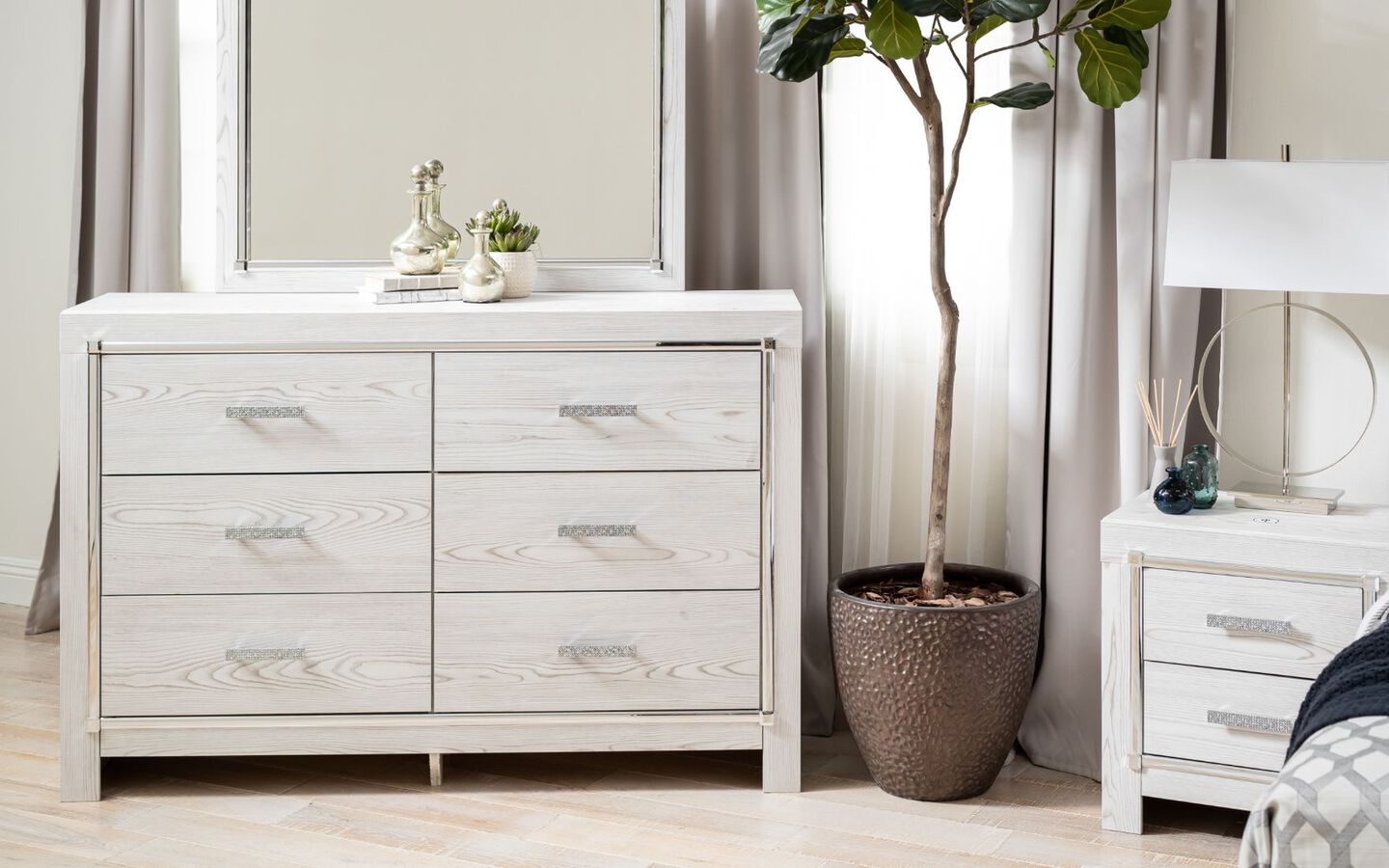 White wooden bedroom dresser with mirror next to matching nightstand
