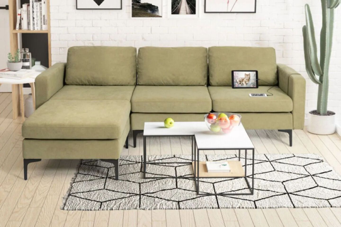 Living room with sage green couch and a white and black coffee table