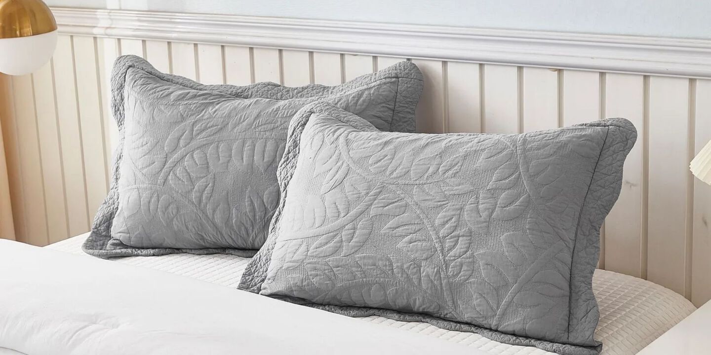 Closeup image of two grey textured pillow shams