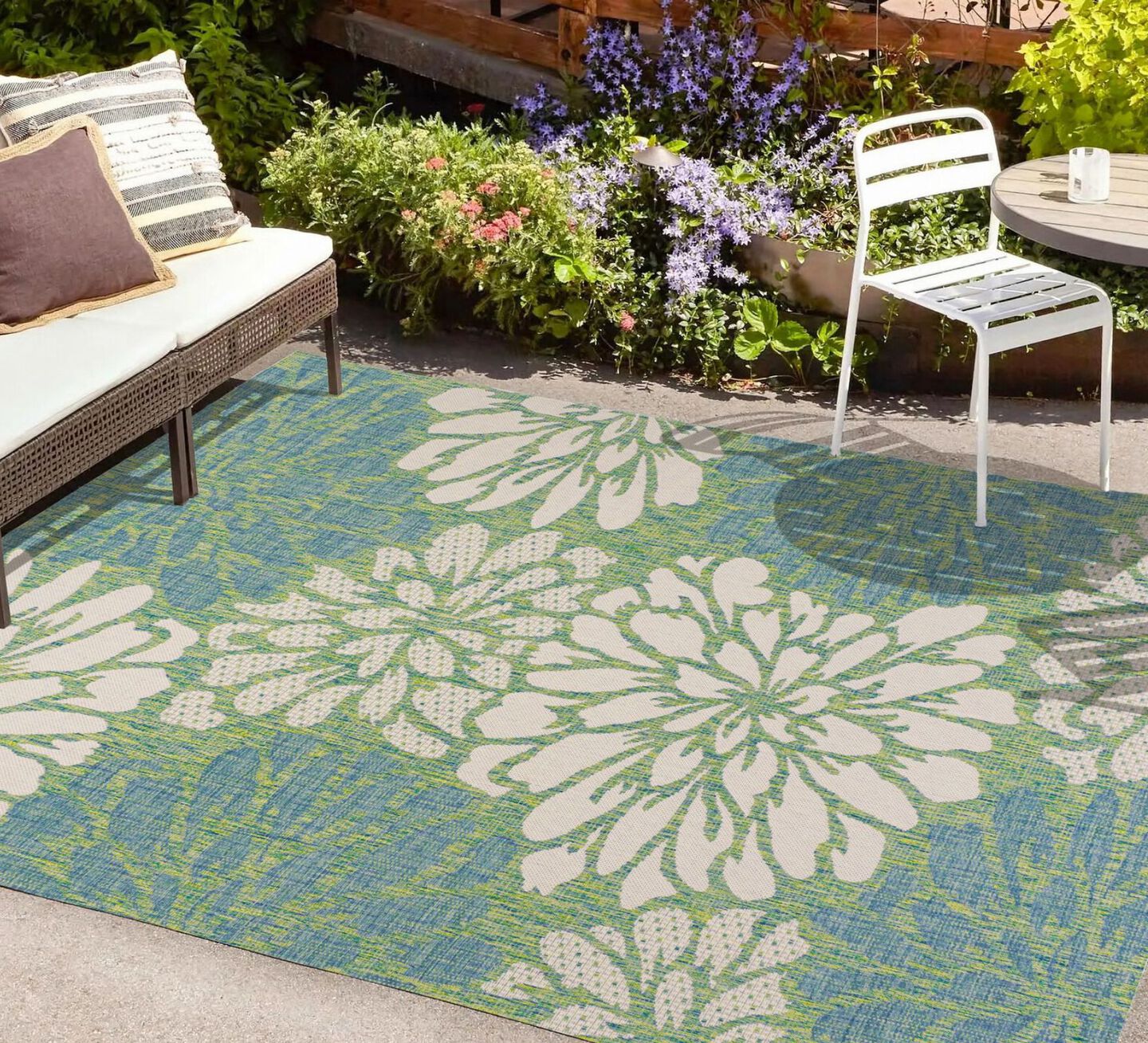 Outdoor rug with a floral white, blue, and green pattern