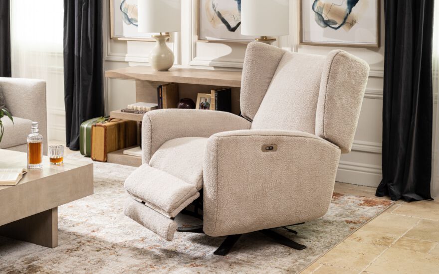 living room setting focused on a light beige plush recliner that is half reclined