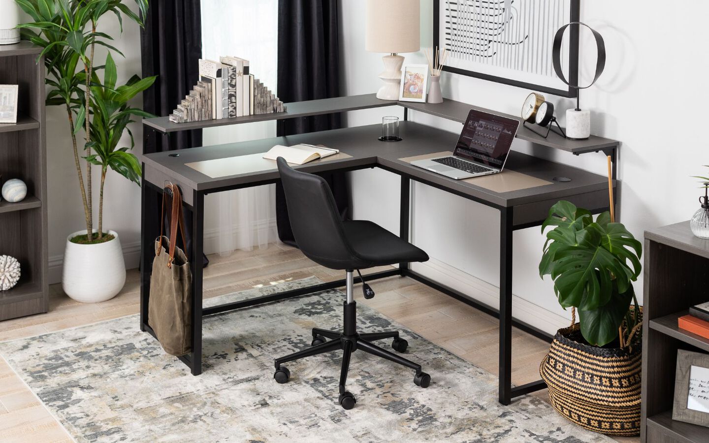 Office with black metal desk and black leather swivel chair