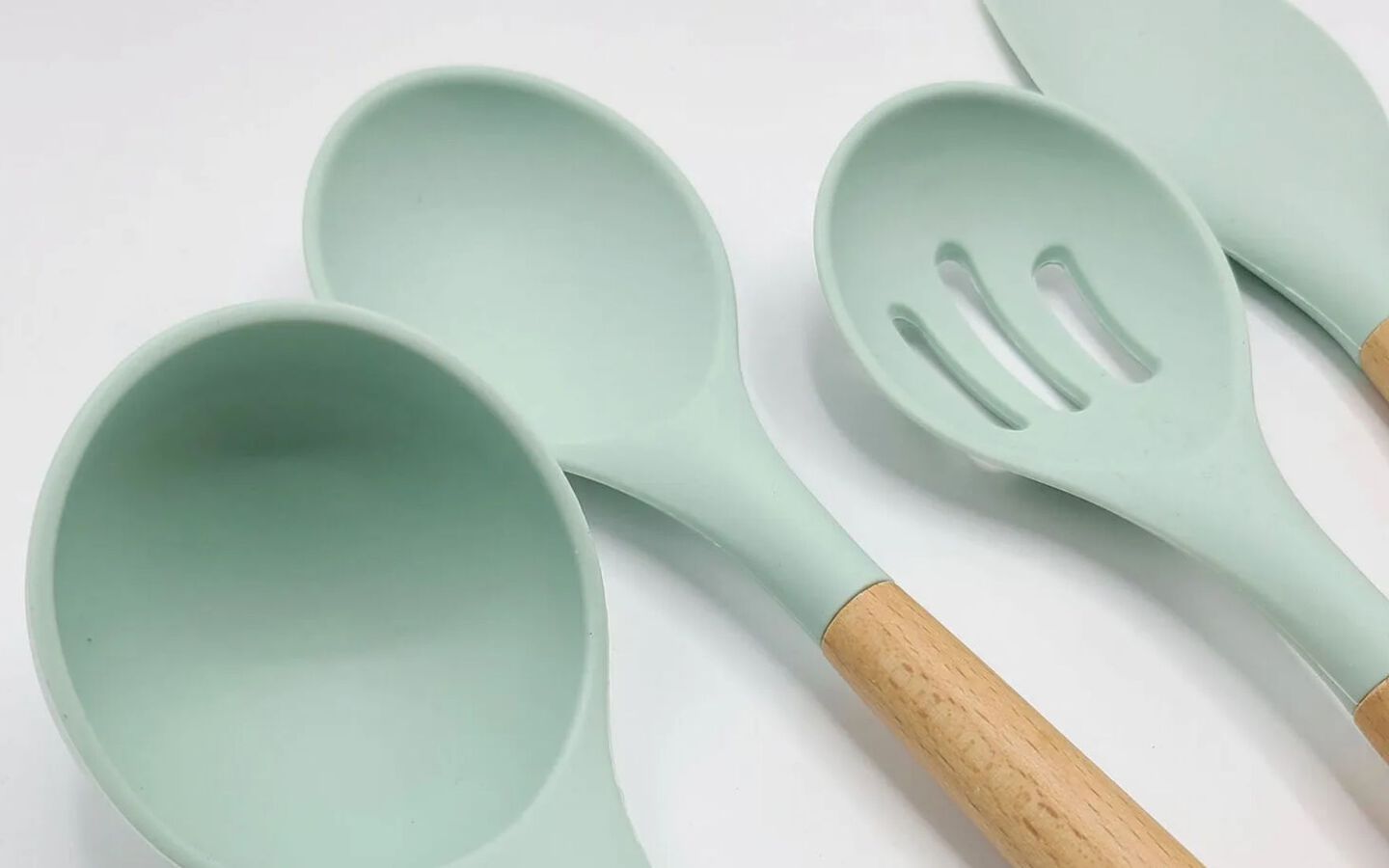 A variety of wooden spoons with mint colored tops