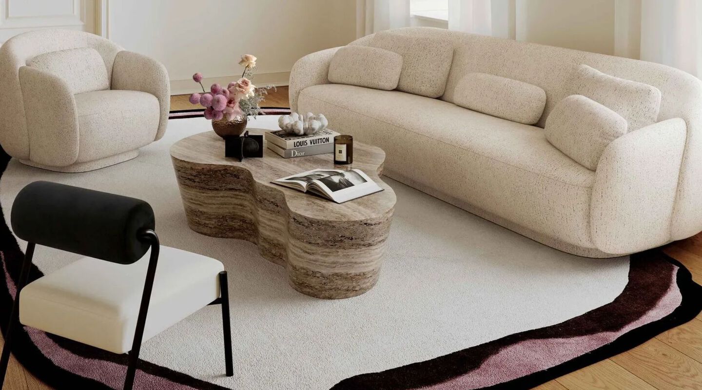 Living room with white plush sofa, a matching chair, and a light brown coffee table