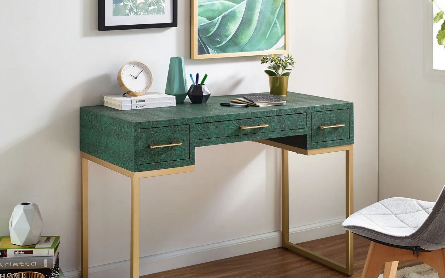 Green and gold desk with various small objects on top