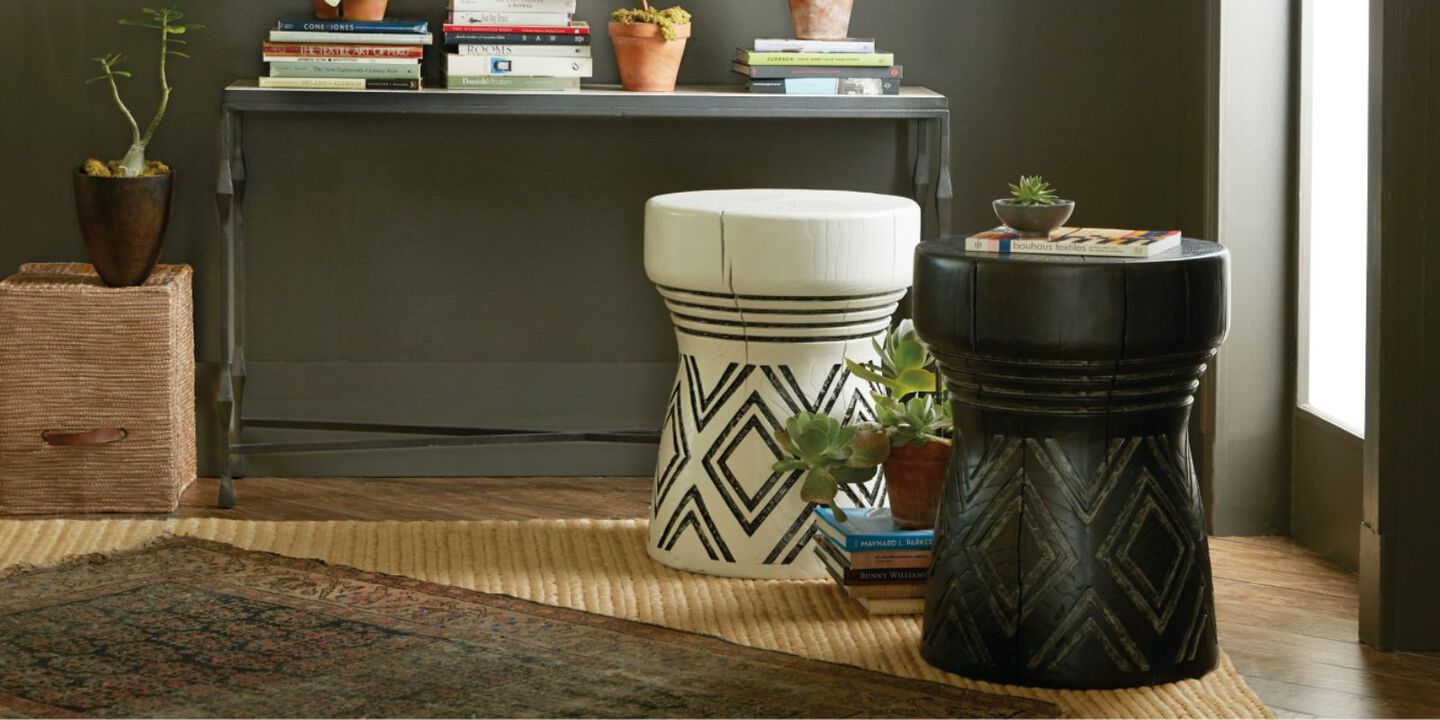 two small side tables, one black, one white, with triangular pattern on each
