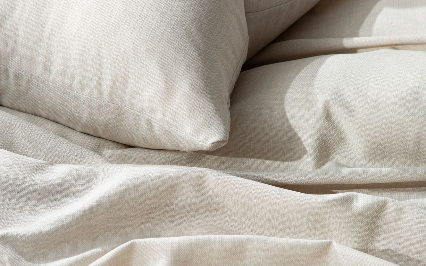 Closeup image of off-white linen bedding