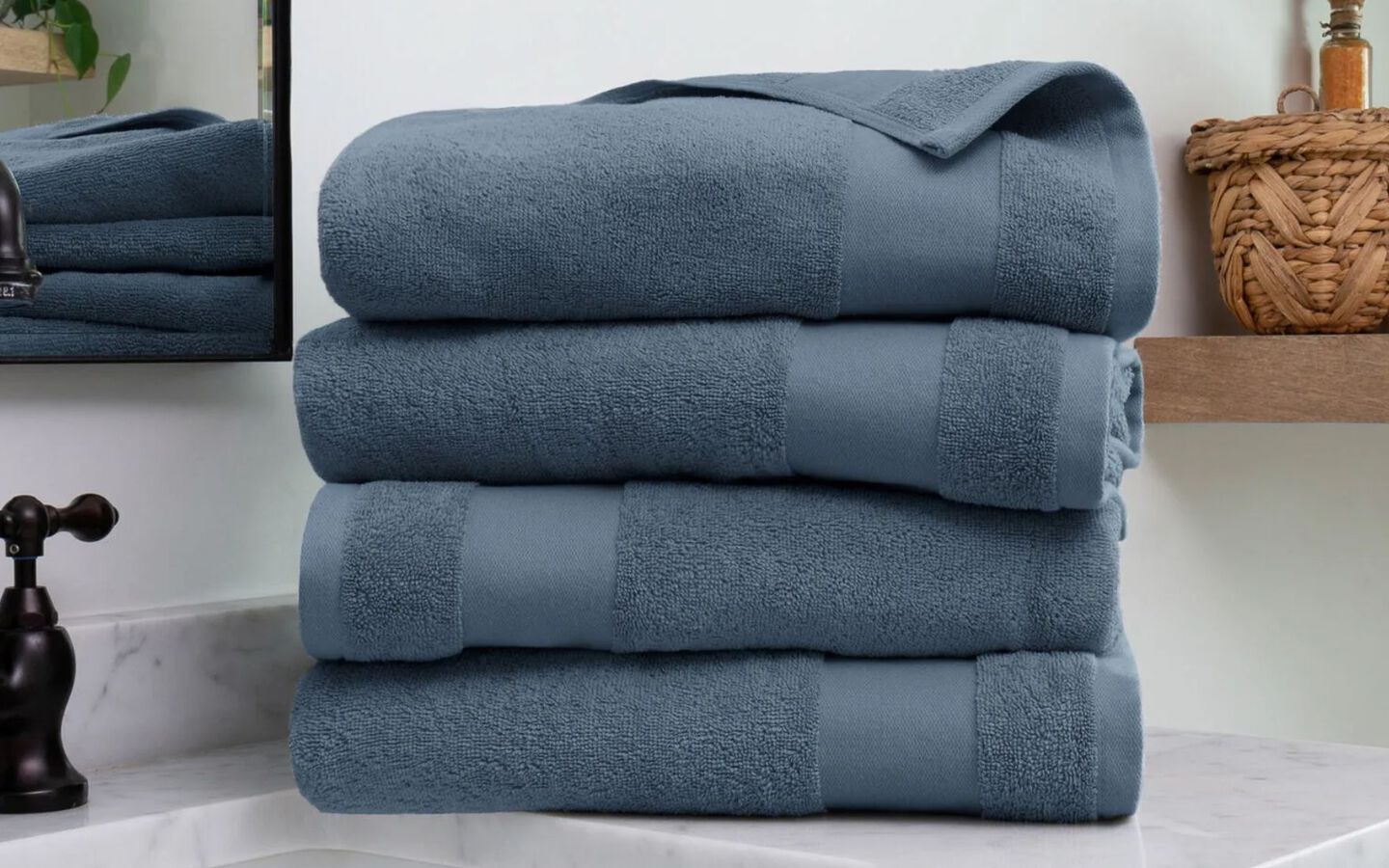 Kitchen counter with four folded blue towels sitting on top