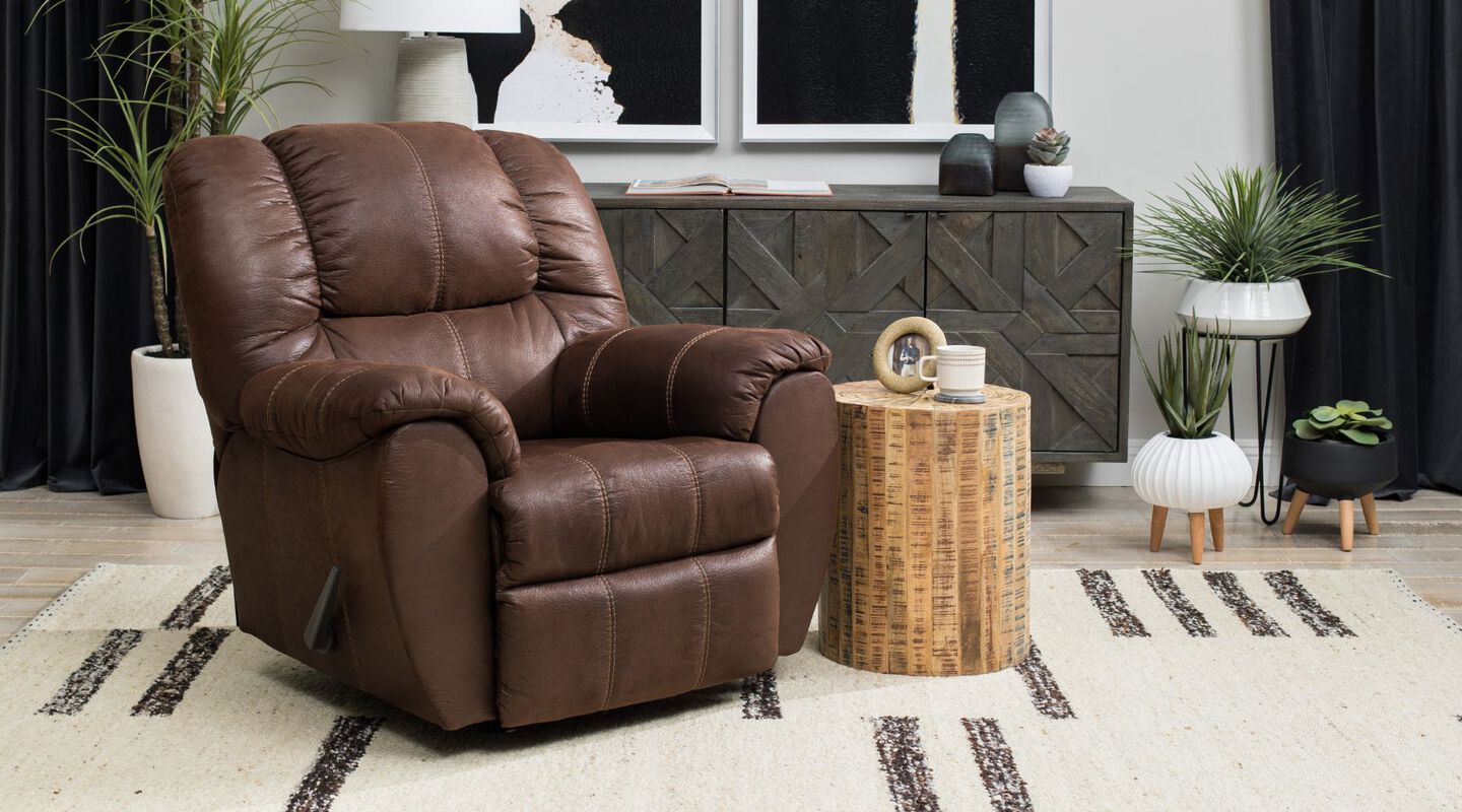 Living room with dark brown recliner next to a small wooden side table
