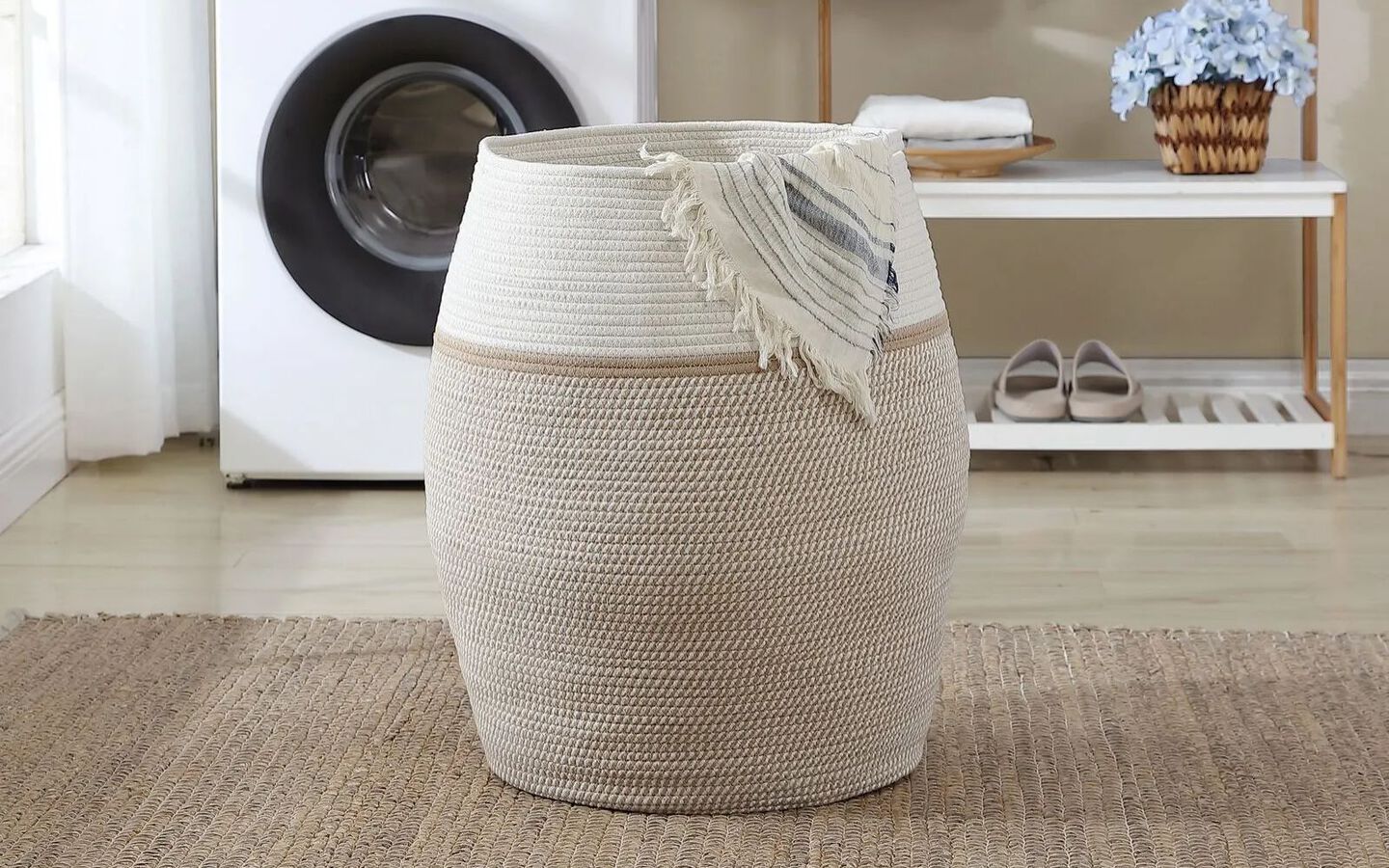 Image of laundry room centered on a beige and white laundry hamper