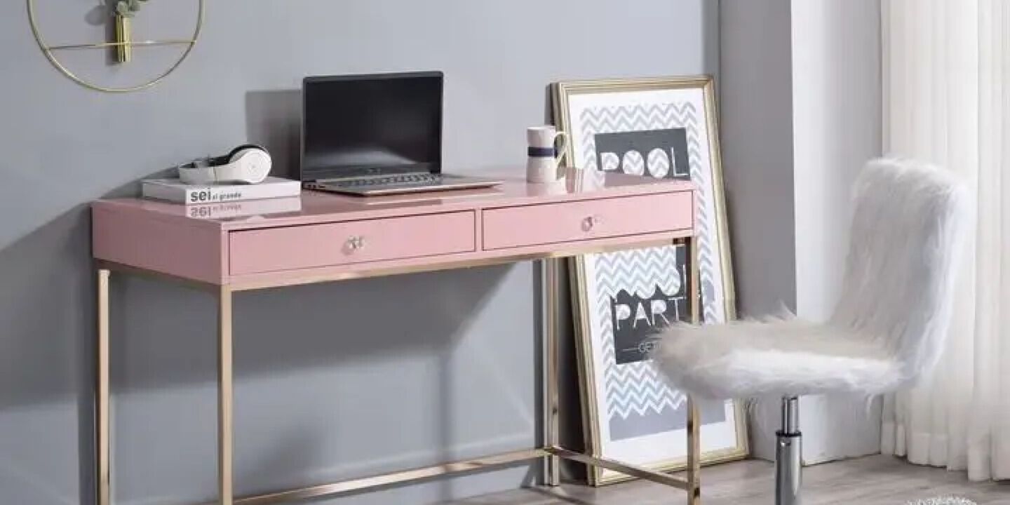 Office space with pink and gold desk and a white fuzzy chair