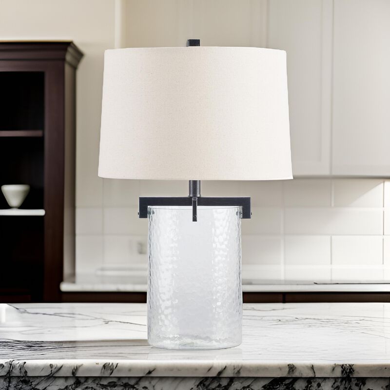 25 Inch Table Lamp, White Drum Shade, Clear Glass Base, Black Metal Frame - Benzara