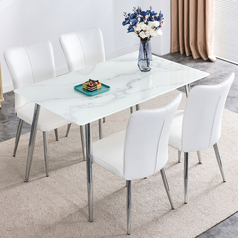 Table and chair set. 1 table with 4 white PU chairs. Modern minimalist rectangular white imitation marble dining table, 0.3 inches thick, with silver metal legs. Paired with 4 PU chairs DT1544 008